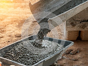 Pouring concrete in to cart mix cement at construction site