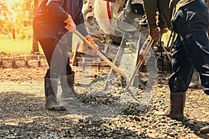 pouring concrete with worker mix cement at construction photo