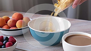 Pouring cornflakes in bowl