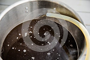 Pouring Craft Home Brew Beer Wort into the Boil Kettle