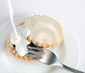 Pouring cream on a mince pie