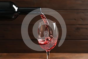 Pouring delicious red wine into glass