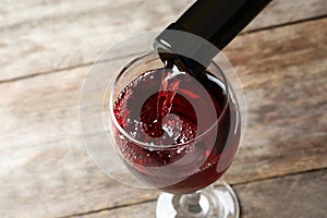 Pouring delicious red wine into glass