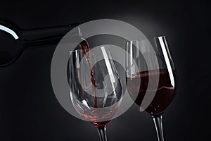 Pouring delicious red wine into glass