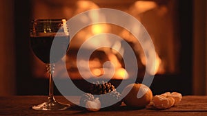 Pouring delicious red wine at romantic fireplace