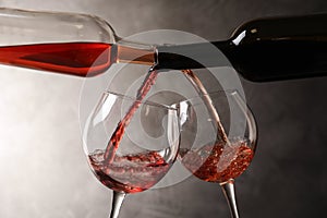 Pouring different wines from bottles into glasses