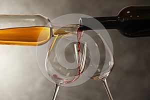 Pouring different wines from bottles into glasses