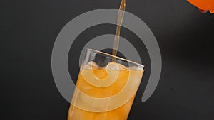 Pouring Fanta in Glass with ice