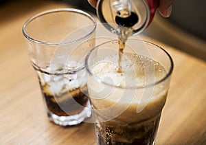 Pouring fizzy drinks into the glass