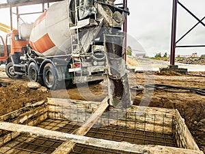 Pouring the foundation with concrete at the construction site. Monolithic reinforced concrete works during the construction of the