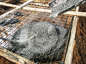 Pouring the foundation with concrete at the construction site. Monolithic reinforced concrete works during the construction of the