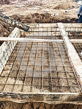 Pouring the foundation with concrete at the construction site. Monolithic reinforced concrete works during the construction of the