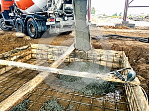 Pouring the foundation with concrete at the construction site. Monolithic reinforced concrete works during the construction of the