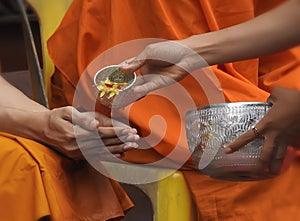 Pouring fragrant water on Buddhist monk hand on So gkran festival in Thailand.  Blessing  tradition for best wishes on new year.