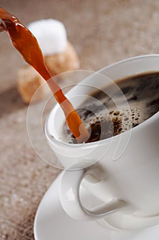 Pouring Fresh Brewed Coffee in white cup photo