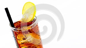 Pouring fresh coke with lime slice and ice cubes isolated on white background