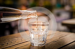 Pouring fresh mineral water into glass