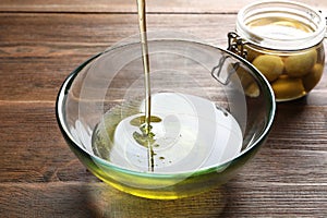 Pouring fresh olive oil into bowl