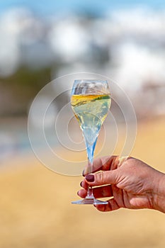 Pouring a glass of champagne on vacation, south of Fuerteventura, Canary islands, blue ocean, mountains