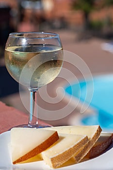 Pouring a glass of champagne on vacation, south of Fuerteventura, Canary islands, blue ocean, mountains