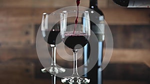 Pouring a glass of red wine in slow motion