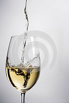 Pouring glass white wine, isolated