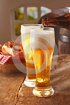 Pouring glasses of frothy beer photo