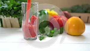 Pouring a healthy vegetable smoothie into a glass