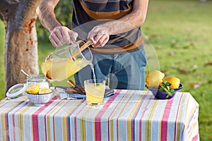 Pouring homemade lemonade in glass