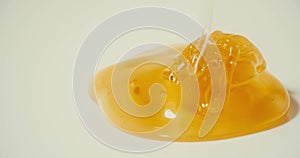 Pouring honey on the plate, macro shot