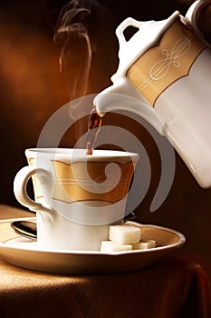 Hot coffee pouring in a cup