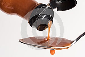 Pouring Hot Sauce on a Spoon