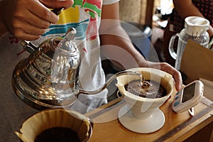 Pouring hot water into coffee drip filter