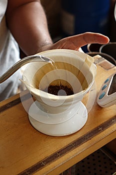 Pouring hot water into coffee drip filter
