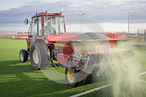 Pouring infill on artificial grass