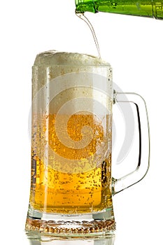 Pouring light beer in a beer mug, it turns out foam and spray