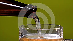Pouring limonade with ice cubes close-up. Cola with Ice and bubbles in glass. Coke Soda closeup. Food background. Rotate
