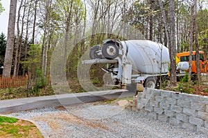 Pouring liquid cement concrete from concrete mixer truck at a construction site