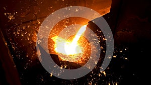 Pouring of liquid metal in open hearth workshop of the metallurgical plant. Stock footage. Smelting of the metal in the