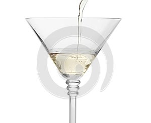 Pouring martini from bottle into glass on white