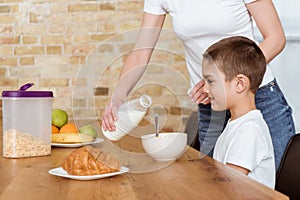 Pouring milk in bowl with cereals