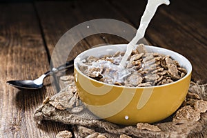 Pouring Milk in a bowl with Cornflakes