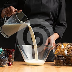 Pouring milk into the breakfast, freezing in motion. Cooking breakfast cereals, granules, breakfast cereals, cereals, berries of