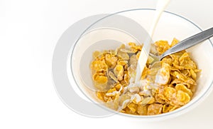 Pouring Milk into corn flake breakfast cereal