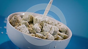 Pouring Milk in Mini Wheats Cereal