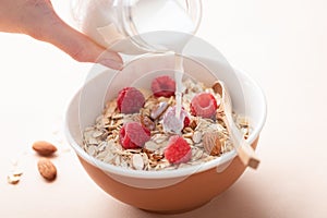 Pouring milk in oat muesli