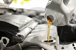 Pouring oil into car engine