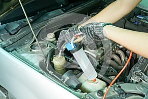 Pouring old power steering fluid with special tool for suction oil, Car service photo