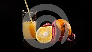 Pouring Orange Juice by Black Background