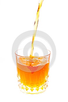 Pouring orange juice into the glass isolated